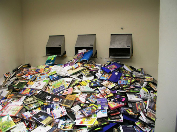 Photo of a huge pile of returned dvds and books