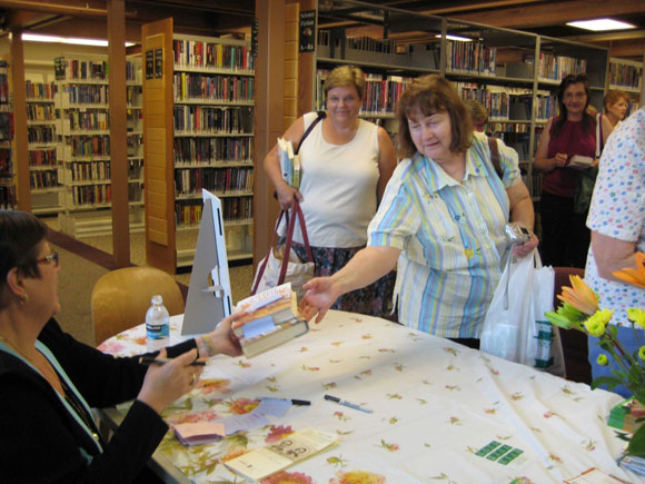 Photo of women at Niles Library handling books