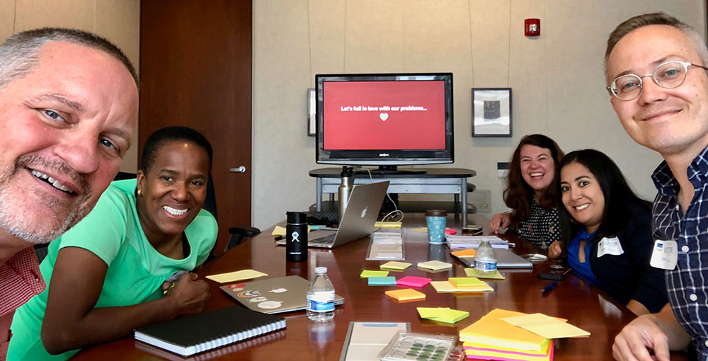 Smiling people at a problem framing workshop