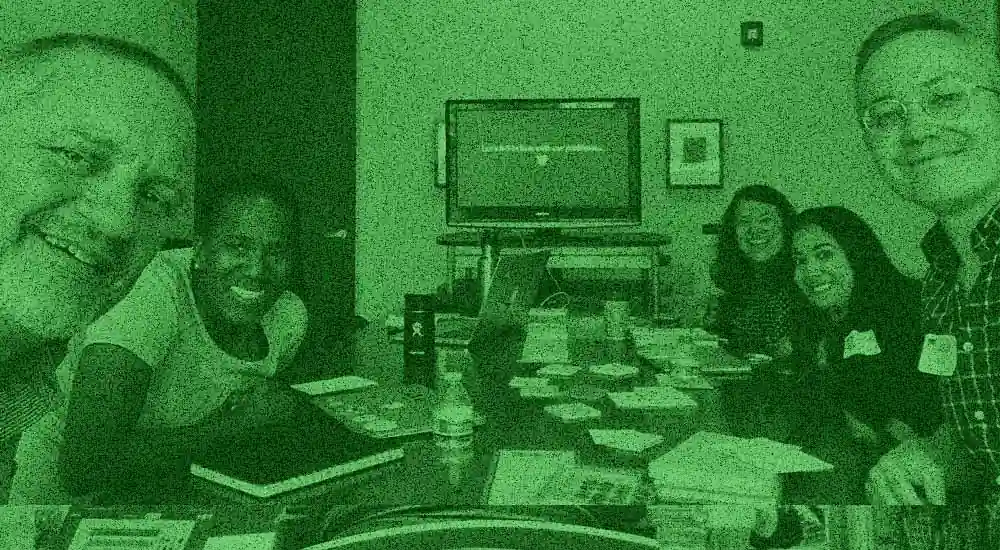 Smiling people at a problem framing workshop